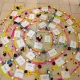 An installation in memory of the victims of the La Gabarra massacre in Colombia: a colorful spiral made of candles, flowers and sheets of paper on which the names of the victims have been written. © Rodrigo Londono
